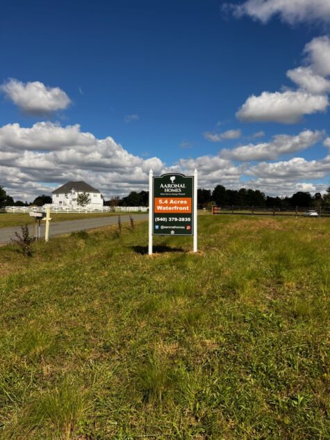 Photo of real estate sign set in large field in Stafford, VA. Sign was manufactured & installed by Distinct Sign Solutions in Fredericksburg, VA