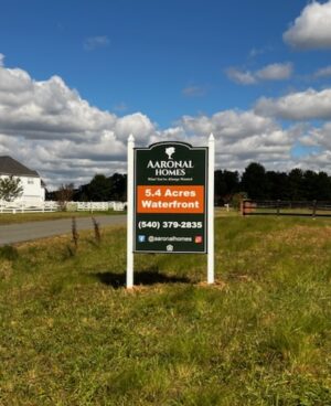 Photo of real estate sign set in large field in Stafford, VA. Sign was manufactured & installed by Distinct Sign Solutions in Fredericksburg, VA