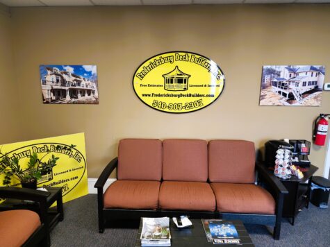 Photo of black & yellow layered acrylic oval wall sign for office in Fredericksburg, VA. Sign was manufactured & installed by Distinct Sign Solutions in Fredericksburg, VA