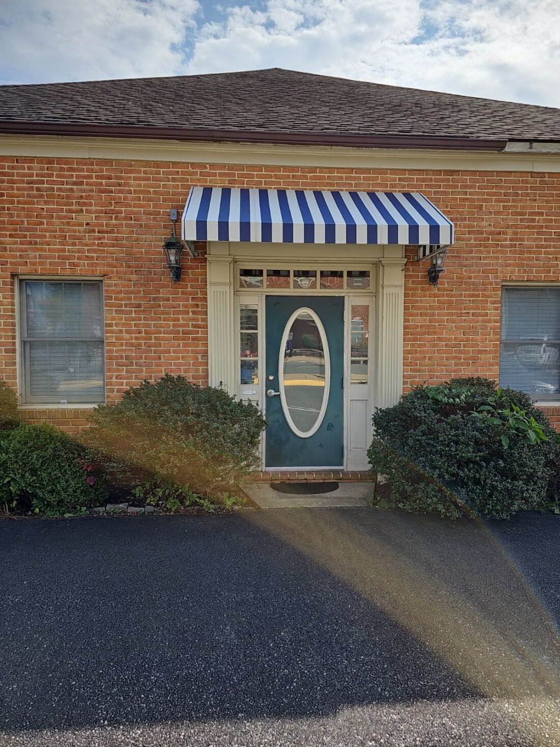 Photo for striped awning located in Fredericksburg, VA. Awning was recovered & installed by Distinct Sign Solutions in Fredericksburg, VA