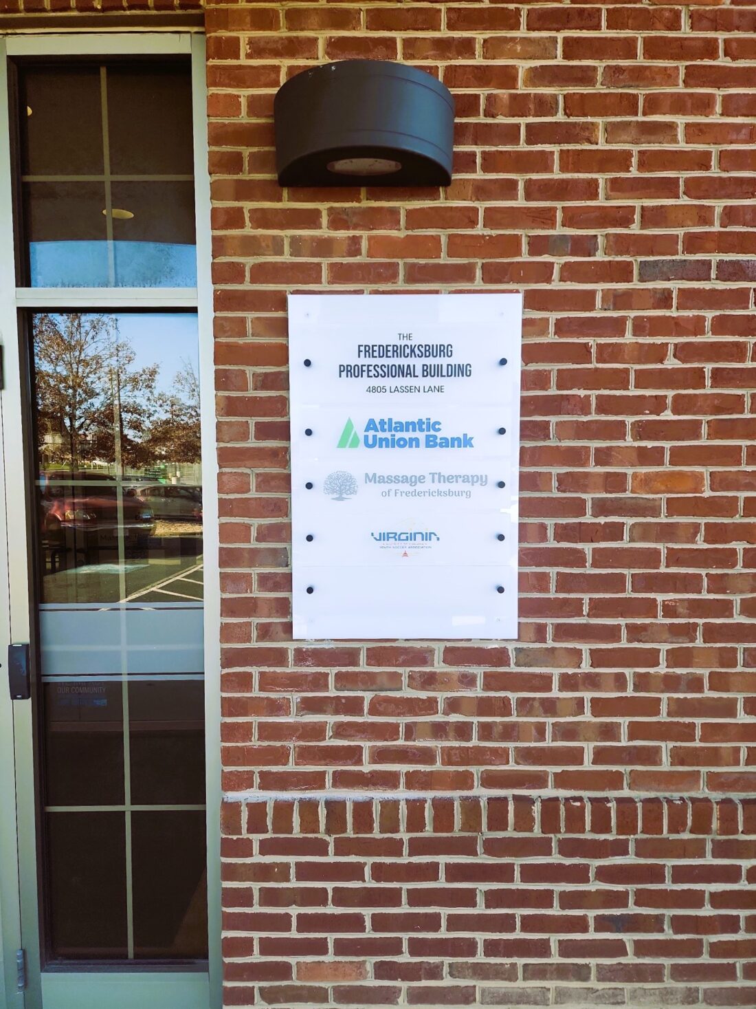 Photo of custom acrylic tenant directory affixed to brick building in Spotsylvania, VA. Sign was manufactured & installed by Distinct Sign Solutions in Fredericksburg, VA