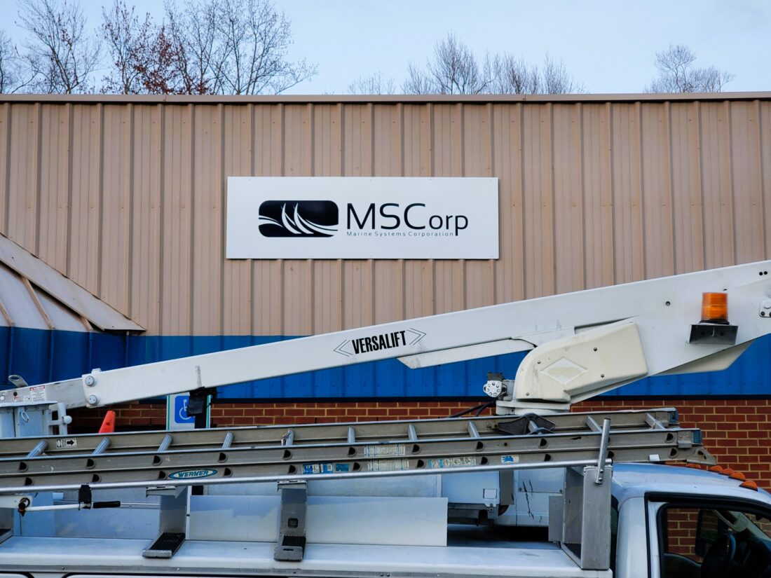 Photo of custom entrance sign on corrugated metal wall in King George, VA. Sign was manufactured & installed by Distinct Sign Solutions in Fredericksburg, VA