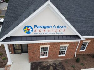 Photo of custom acrylic sign on EIFS wall, as viewed from bucket truck, in Spotsylvania, VA. Sign was manufactured & installed by Distinct Sign Solutions in Fredericksburg, VA