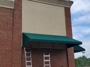 Photo of green awning in Ladysmith, VA. Awning was recovered by Distinct Sign Solutions in Fredericksburg, VA