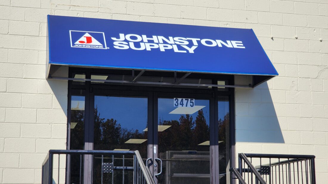 An blue awning featuring the logo for Johnston Supply, installed by Distinct Sign Solutions in Fredericksburg, VA.