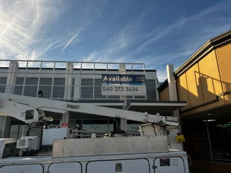 Photo of bucket truck sitting in front of newly installed Colliers Available Banner in Spotsylvania, VA. Banner was manufactured & installed by Distinct Sign Solutions in Fredericksburg, VA