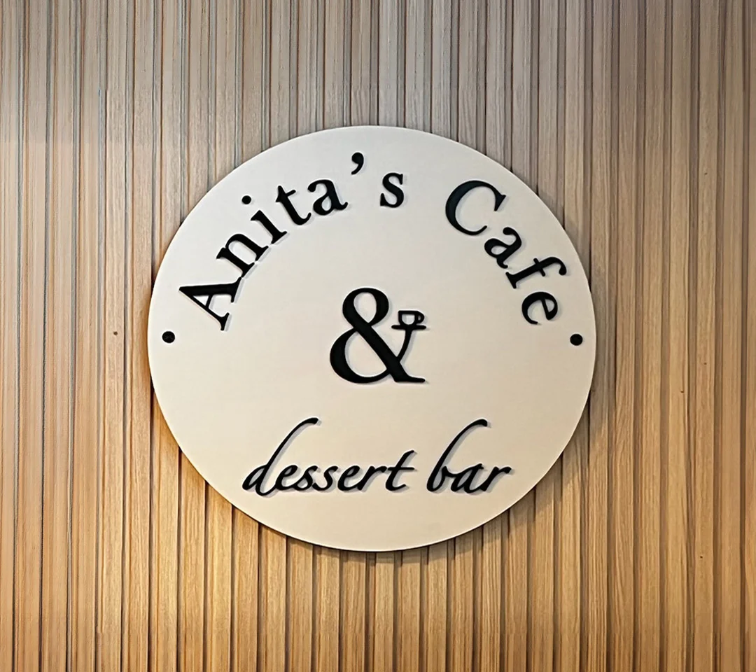 Round interior sign for Anita’s Cafe & Dessert Bar in Downtown Fredericksburg, designed and crafted by Distinct Sign Solutions in Fredericksburg, VA, to showcase the cafe’s elegant new signage under new ownership.