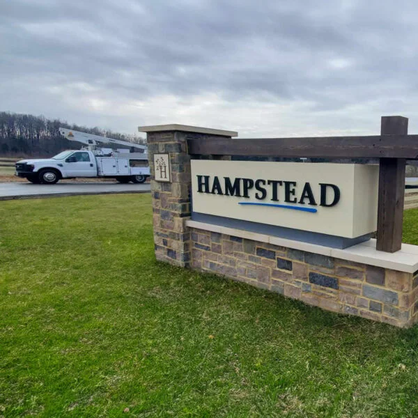 Elegant and durable monument sign for Atlantic Builders Hampstead in Stafford, created by Distinct Sign Solutions in Fredericksburg, VA, featuring a new signage with stone and metal elements to create a welcoming community entrance.