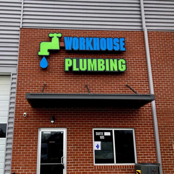 Vibrant illuminated channel letter sign for Workhouse Plumbing in Stafford, created by Distinct Sign Solutions in Fredericksburg, VA, featuring bold colors and a professional design for high visibility.