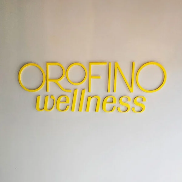 Minimalist yellow signage for Orofino Wellness in Downtown Fredericksburg, designed and installed by Distinct Sign Solutions in Fredericksburg, VA, adding a welcoming touch to the space.