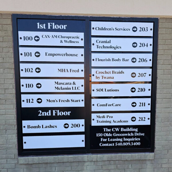 Exterior multi-tenant directory sign at CW Building, using modular panels for seamless tenant name updates.