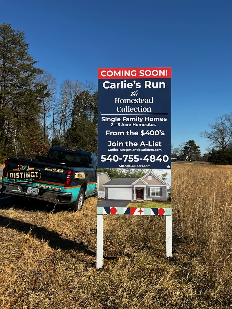 Photo of large post & panel sign for Atlantic Builders in large field in Mineral VA. Sign was manufactured & installed by Distinct Sign Solutions in Fredericksburg, VA.