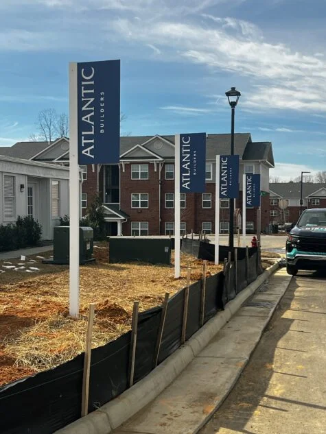 Photo of multiple aluminum blade/flag signs for Atlantic Builders in Spotsylvania, VA. Signs were manufactured & installed by Distinct Sign Solutions in Fredericksburg, VA