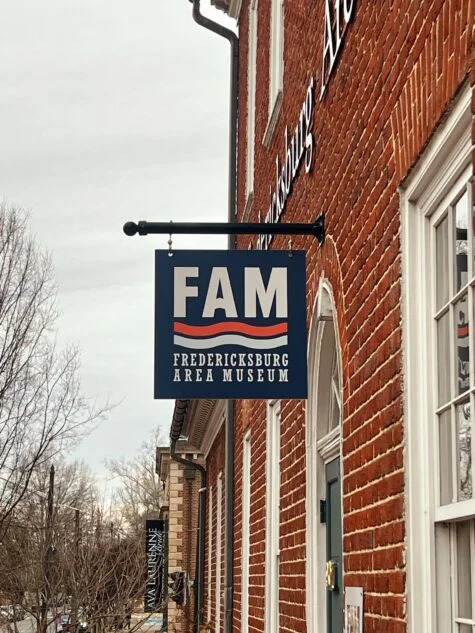 Photo of hanging blade sign on steel bracket for FAMVA, located in Fredericksburg, VA. Sign was manufactured & installed by Distinct Sign Solutions in Fredericksburg, VA
