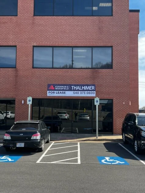 Photo of banner mounted to brick building in Dumfries, VA. Banner was manufactured & installed by Distinct Sign Solutions in Fredericksburg, VA