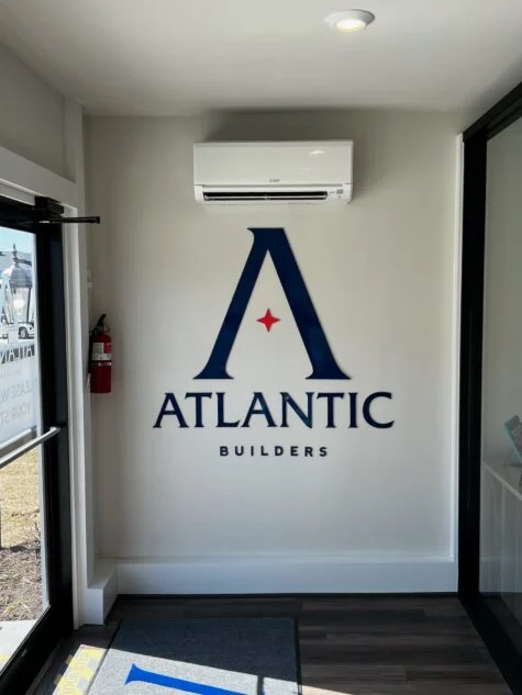 Photo of entrance wall with custom Atlantic Builders acrylic wall sign in Spotsylvania, VA. Sign was manufactured & installed by Distinct Sign Solutions in Fredericksburg, VA