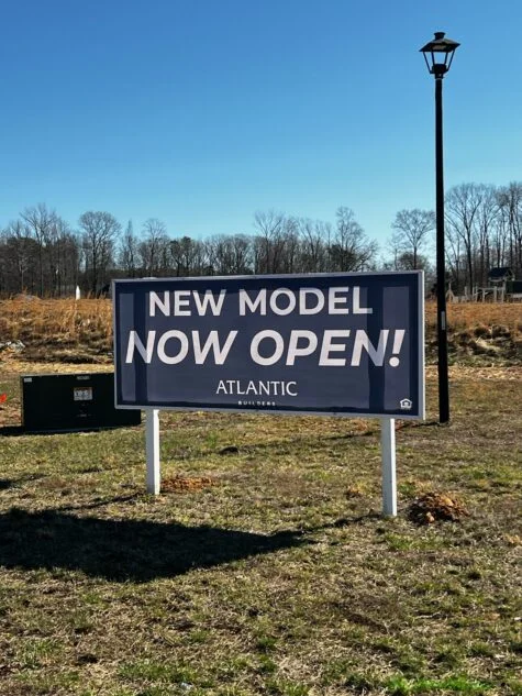 Photo of blue & white banner affixed to post structure in Spotsylvania, VA field. Banner was manufactured & installed by Distinct Sign Solutions in Fredericksburg, VA
