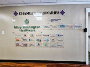 Photo of multiple acrylic wall signs displayed on drywall in entrance of Fredericksburg VA's chamber of commerce. Signs were manufactured & installed by Distinct Sign Solutions in Fredericksburg, VA