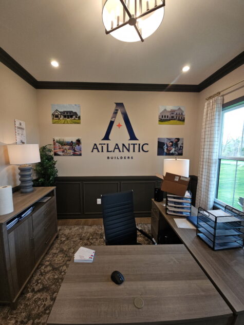Photo of receptionist area with Atlantic Builders acrylic logo & various acrylic prints in Stafford, VA model home. Signs were manufactured & installed by Distinct Sign Solutions in Fredericksburg, VA
