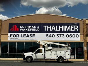 Photo of very large banner mounted to EIFS wall in Stafford, VA for Thalhimer. Banner was manufactured & installed by Distinct Sign Solutions in Fredericksburg, VA