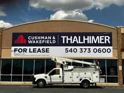 Photo of very large banner mounted to EIFS wall in Stafford, VA for Thalhimer. Banner was manufactured & installed by Distinct Sign Solutions in Fredericksburg, VA