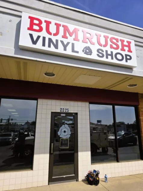 Photo of black & red push through acrylic channel letter sign for vinyl shop in Fredericksburg, VA. Sign was manufactured & installed by Distinct Sign Solutions in Fredericksburg, VA