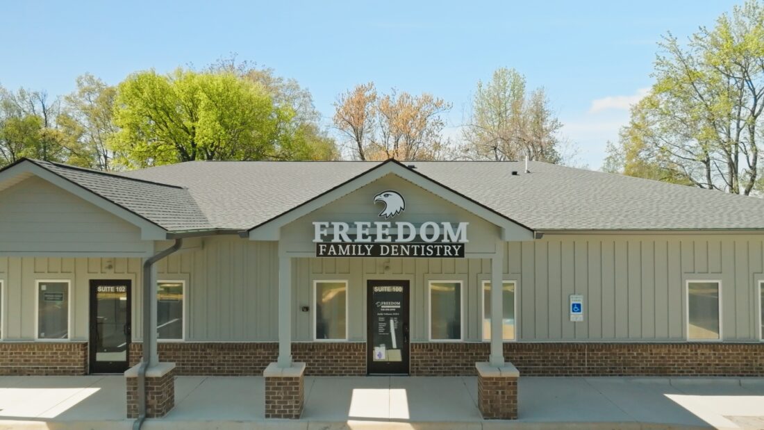 Photo of custom channel letter sign mounted to front gable of building in Spotsylvania, VA dental office. Sign was manufactured & installed by Distinct Sign Solutions in Fredericksburg, VA