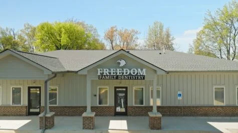 Photo of custom channel letter sign mounted to front gable of building in Spotsylvania, VA dental office. Sign was manufactured & installed by Distinct Sign Solutions in Fredericksburg, VA