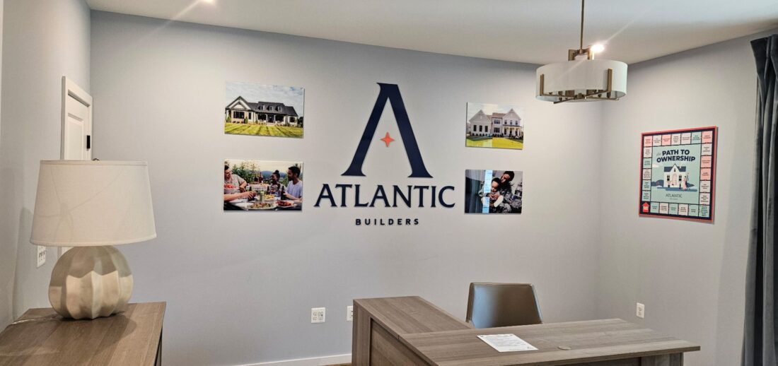 Photo of model home wall with various acrylic signage in Spotsylvania, VA. Signs were manufactured & installed by Distinct Sign Solutions in Fredericksburg, VA
