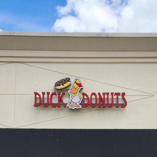 Finished Duck Donuts building sign with channel letters and mascot installed by Distinct Sign Solutions