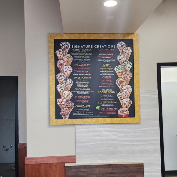 Interior menu signage at Cold Stone Creamery featuring their Signature Creations display.
