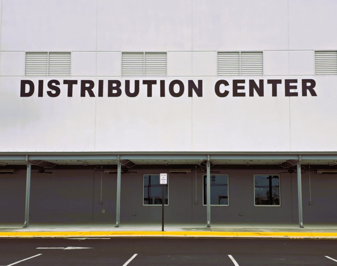 Photo of large black letters reading DISTRIBUTION CENTER mounted to EIFS wall on O'Reilly Auto Parts Distribution Center in Stafford, VA. Sign was manufactured & installed by Distinct Sign Solutions in Fredericksburg, VA