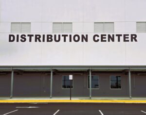 Photo of large black letters reading DISTRIBUTION CENTER mounted to EIFS wall on O'Reilly Auto Parts Distribution Center in Stafford, VA. Sign was manufactured & installed by Distinct Sign Solutions in Fredericksburg, VA