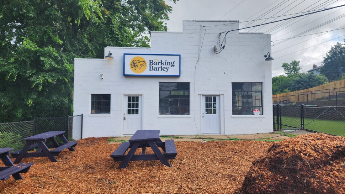 Photo of The Barking Barley Sign cabinet mounted to white building in Fredericksburg, VA. Sign was manufactured & installed by Distinct Sign Solutions in Fredericksburg, VA