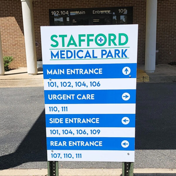 Freestanding sign outside Stafford Medical Park listing entrances and suite groupings with directional arrows