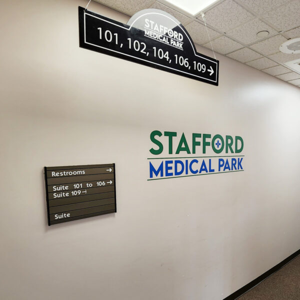 Interior hallway at Stafford Medical Park showing suite numbers and directional signage