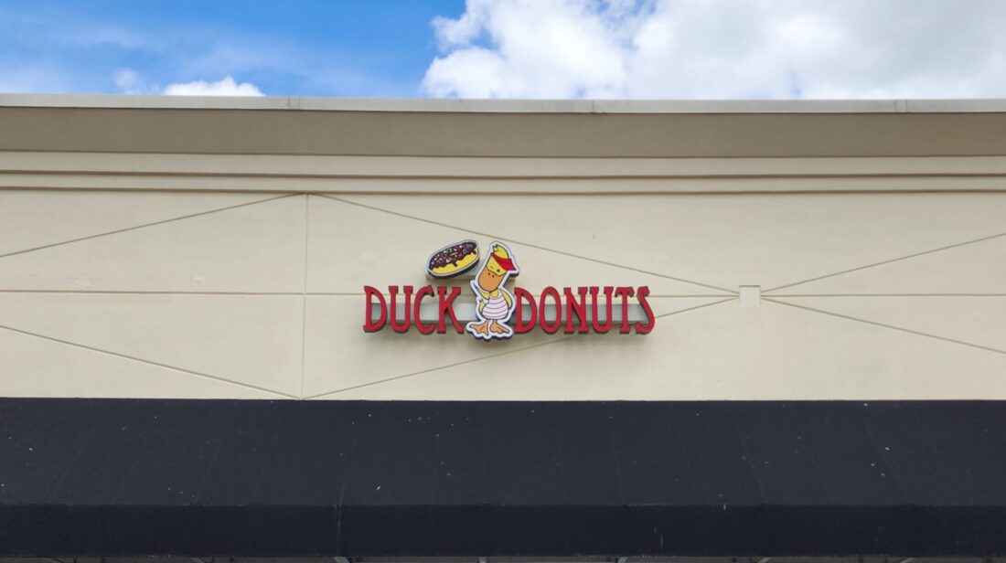 Photo of Duck Donuts Channel letter sign mounted to EIFS wall at local doughnut shop in Fredericksburg, VA. Sign was manufactured & installed by Distinct Sign Solutions in Fredericksburg, VA