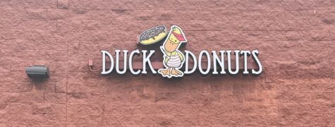 Photo of Duck Donuts channel letter sign mounted to block wall in Fredericksburg, VA. Sign was manufactured & installed by Distinct Sign Solutions in Fredericksburg, VA.