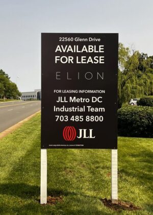 Photo of Black, white, and red post & panel sign in grassy area in Sterling, VA. Sign was manufactured & installed by Distinct Sign Solutions in Fredericksburg, VA