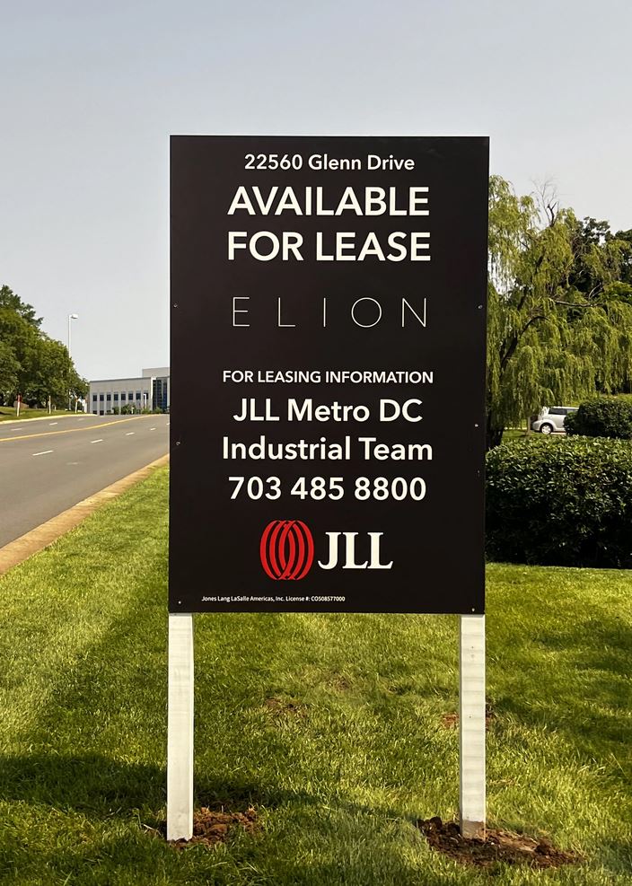 Photo of Black, white, and red post & panel sign in grassy area in Sterling, VA. Sign was manufactured & installed by Distinct Sign Solutions in Fredericksburg, VA