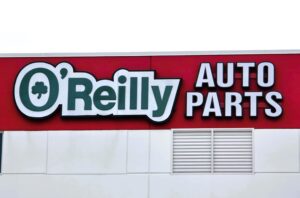 Up close photo of O'Reilly Auto Parts channel letter sign mounted to red painted EIFS wall in Stafford, VA. Sign was installed by Distinct Sign Solutions in Fredericksburg, VA