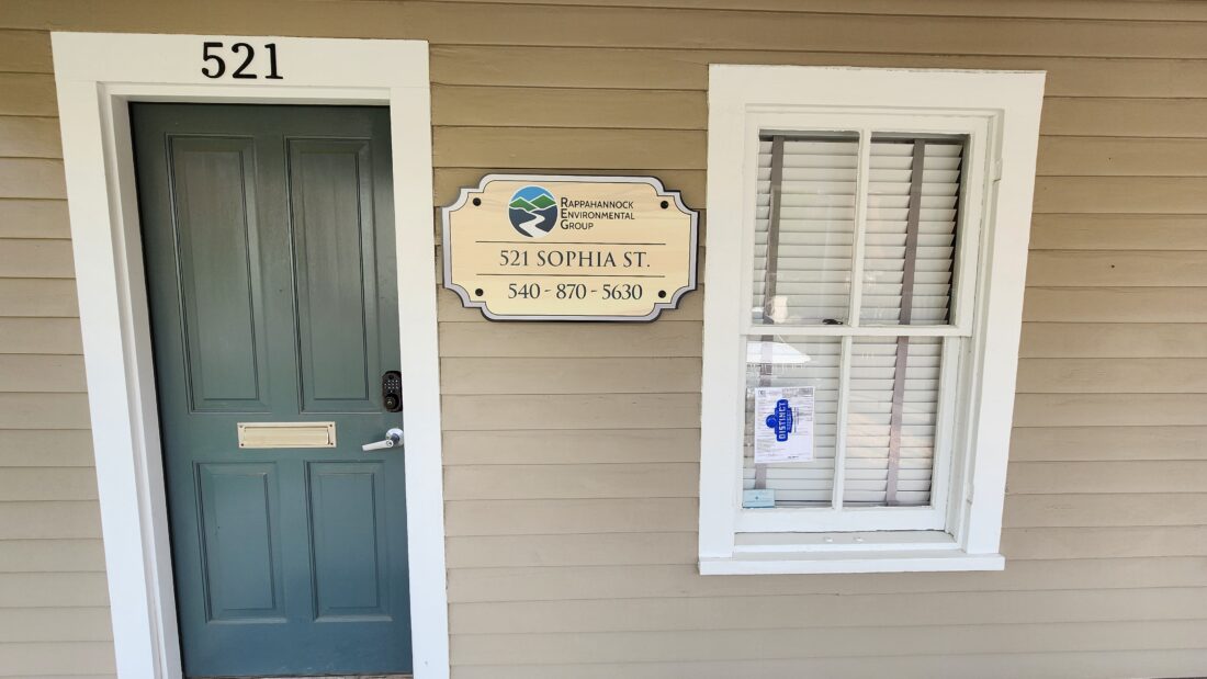 Photo of acrylic building mounted sign on standard siding paneled building in Fredericksburg, VA. Sign was manufactured & installed by Distinct Sign Solutions in Fredericksburg, VA