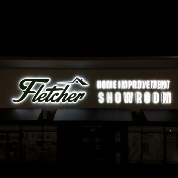 Fletcher Home Improvement Showroom façade at night featuring UL-Listed halo-lit channel letters and tagline.