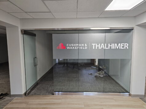 Photo of frosted, red, and white vinyl graphics to glass panes in conference room for Thalhimer in Fredericksburg, VA. Graphics were manufactured & installed by Distinct Sign Solutions in Fredericksburg, VA
