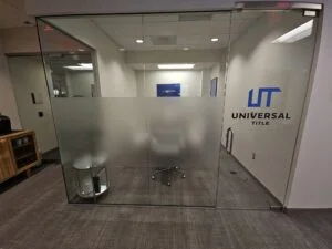 Photo of interior conference room for Universal Title in Fairfax VA. Frosted Vinyl and colored vinyl was applied to glass walls. Graphics were manufactured & installed by Distinct Sign Solutions in Fredericksburg, VA