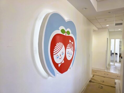 Photo of halo illuminated wall sign for Red Apple Dentistry mounted to drywall in Stafford, VA. Sign was manufactured & installed by Distinct Sign Solutions in Fredericksburg, VA