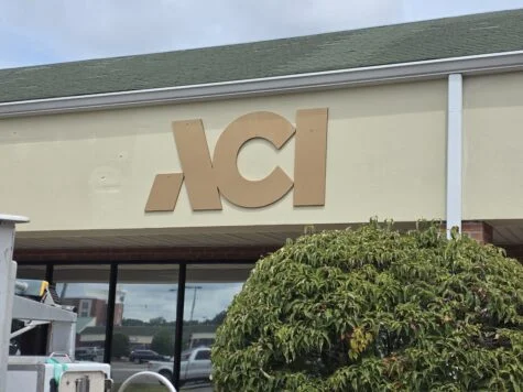 Photo of metallic gold acrylic logo stating ACI mounted to EIFS wall in Spotsylvania, VA. Sign was manufactured & installed by Distinct Sign Solutions in Fredericksburg, VA