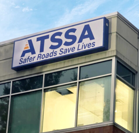 Photo of blue cabinet with white flex face insert showing off ATSSA logo. Sign is mounted to tall building in Stafford, VA. Sign was manufactured & installed by Distinct Sign Solutions in Fredericksburg, VA