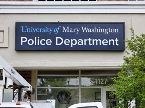 Photo of blue illuminated sign cabinet with University of Mary Washington Police Department logo. Cabinet is mounted to EIFS wall in Fredericksburg, VA. Sign was manufactured & installed by Distinct Sign Solutions in Fredericksburg, VA