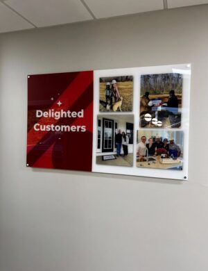 Photo of custom printed acrylic wall sign affixed with standoffs on office wall. Sign was designed, manufactured & installed by Distinct Sign Solutions in Fredericksburg, VA